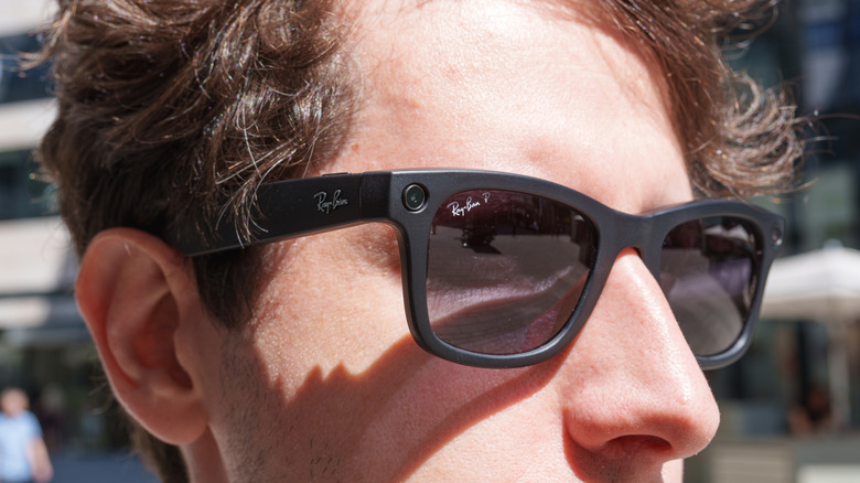 Person wearing Ray-Ban Meta smart glasses.