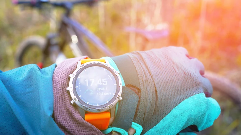 Cyclist wearing a GPS smartwatch.