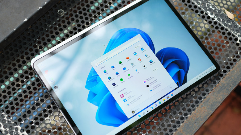 A Surface device open to the Windows 11 desktop with its Start menu open.