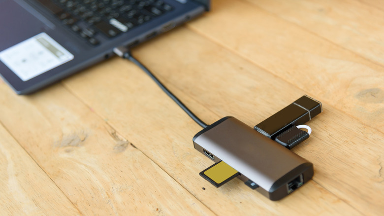 A USB-C hub connected to a laptop on a table
