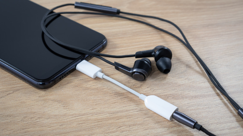 iPhone with a 3.5mm adapter connected