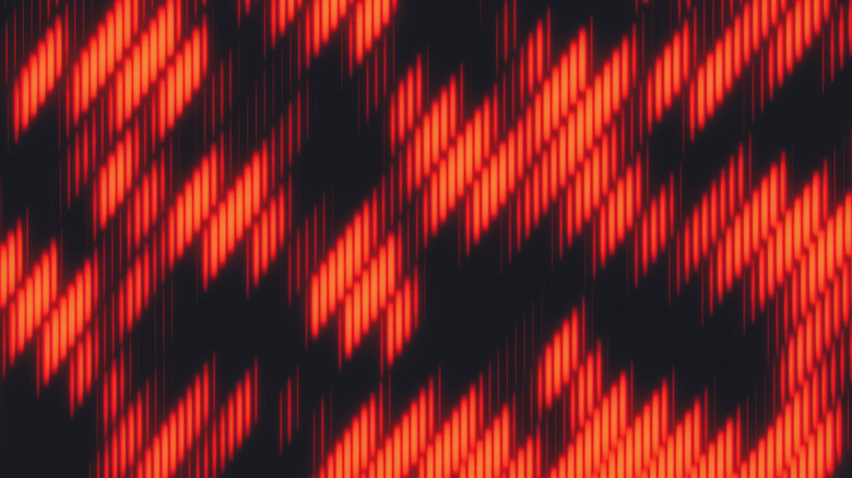 Abstract red digital wave patterns glowing against a dark background.