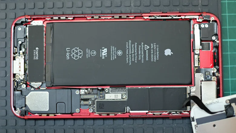 The back of an iPhone, showing its inside with the cover off.