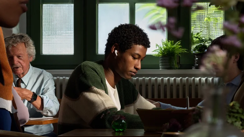 A fashionable young man listening to music on his AirPods.