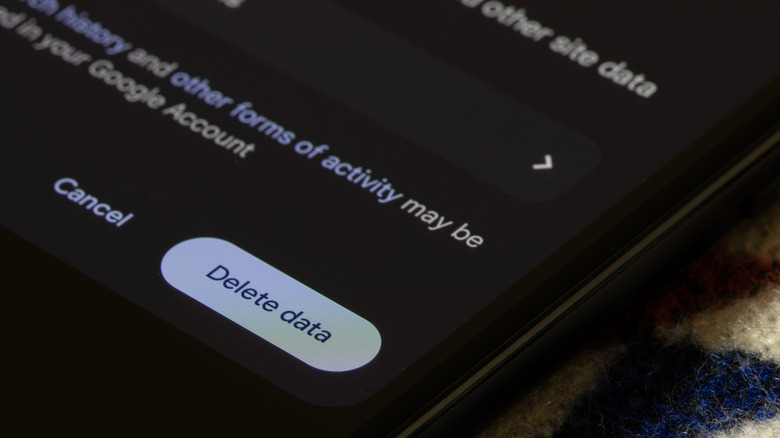 Close-up of an Android phone showing a "Delete data" button in app storage settings.