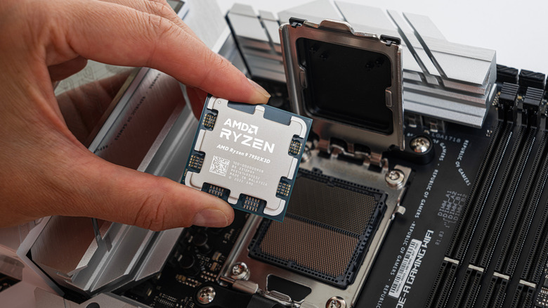 Person installing a Ryzen CPU into a motherboard
