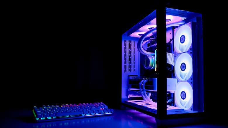 Lit up desktop computer near keyboard.