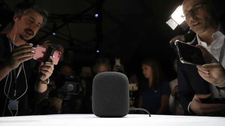 Apple HomePod prototype being filmed by a crowd.