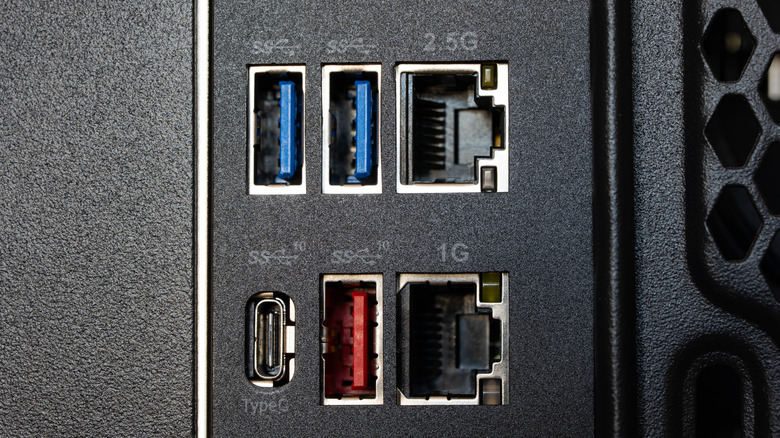 Close-up of various USB-A, Ethernet and USB-C ports on the back of a desktop PC.