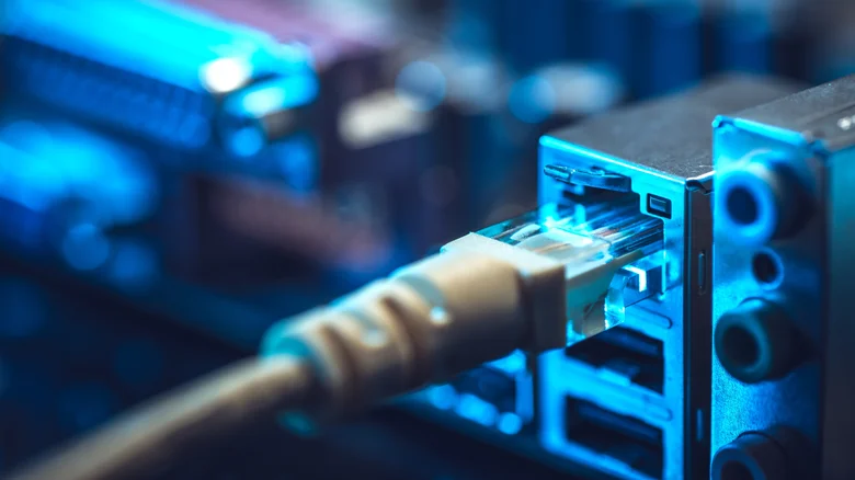 Close-up of an Ethernet cable plugged into the network port on a motherboard.