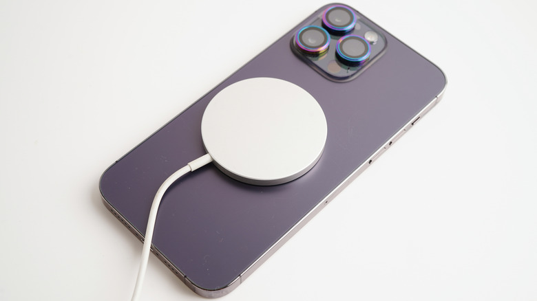 A wireless charging puck on the back of a smartphone.