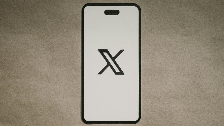 The X logo on an iPhone screen.