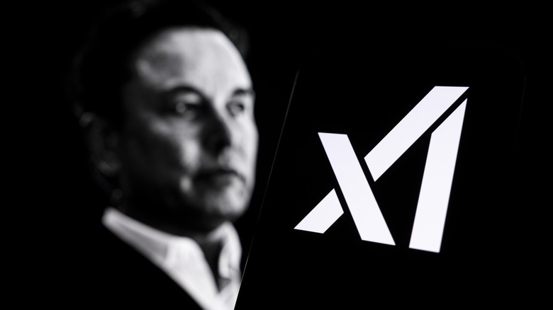Elon Musk with the xAI logo in front.