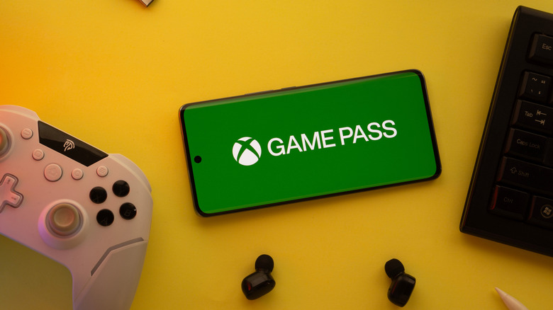 A Game Pass logo on a smartphone.