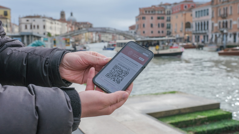 A QR code on a phone in Venice, Italy