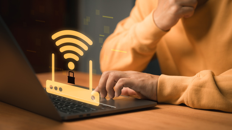 Person using a laptop with an illustrated Wi-Fi router and security lock overlay.