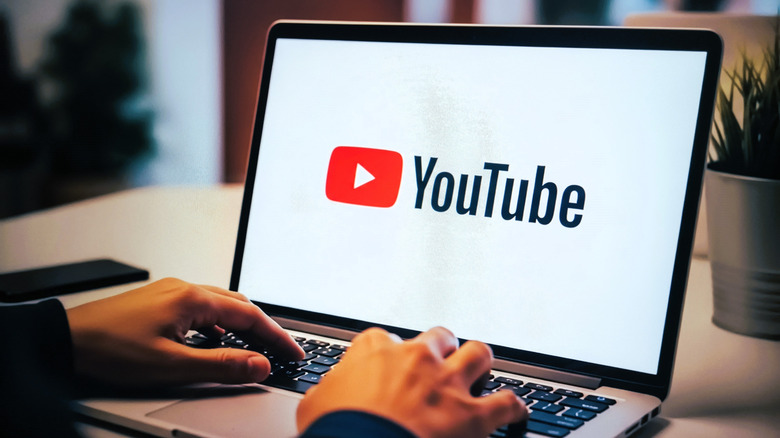 Someone going to YouTube on a laptop