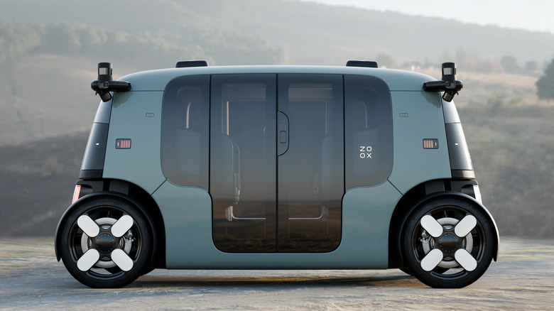 A Zoox robotaxi viewed from the side with its doors closed.