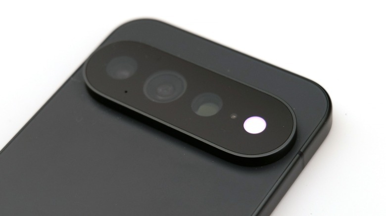 The rear of a Google Pixel phone with a lightly colored circle of light around the flash.