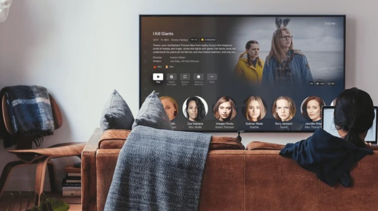 A woman watches Plex on a TV.