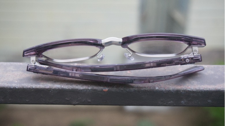 The glasses folded up from the back. The action button is visible.