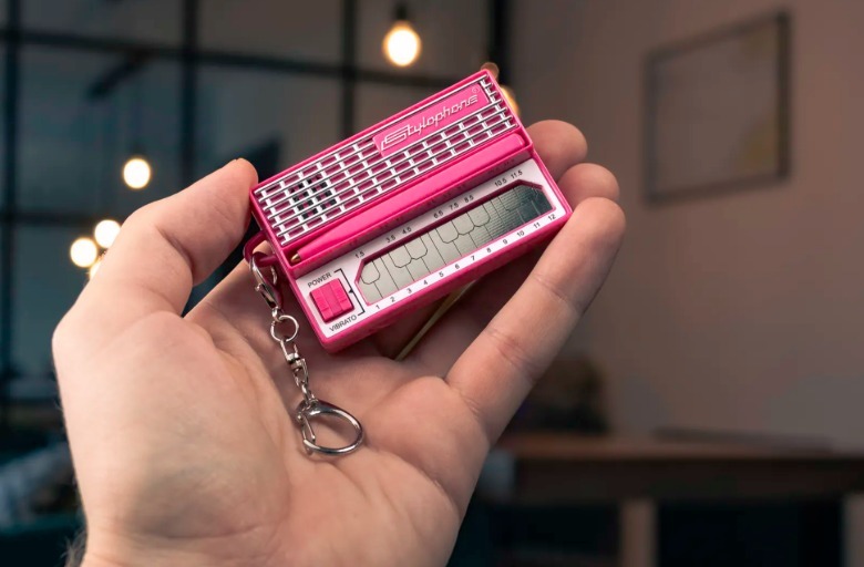 A pink instrument in a hand.