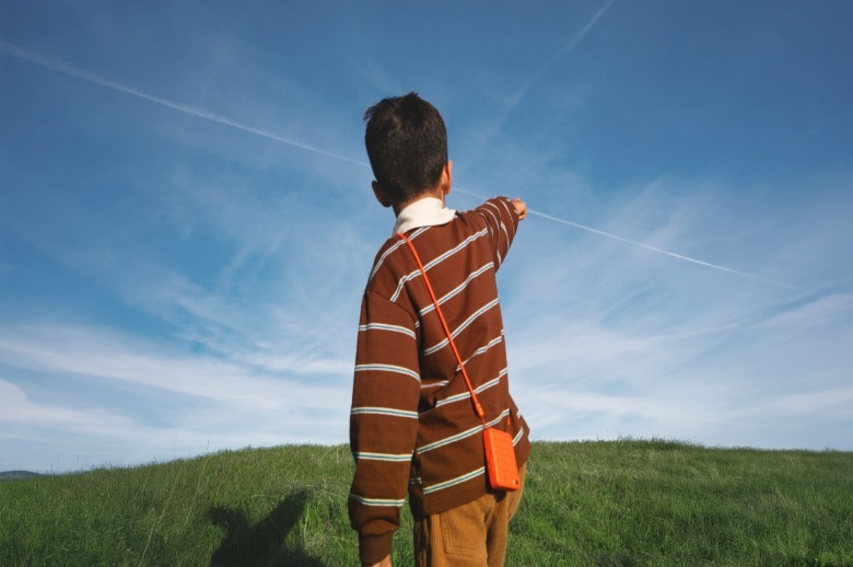 A child wearing a Freckle smartphone.