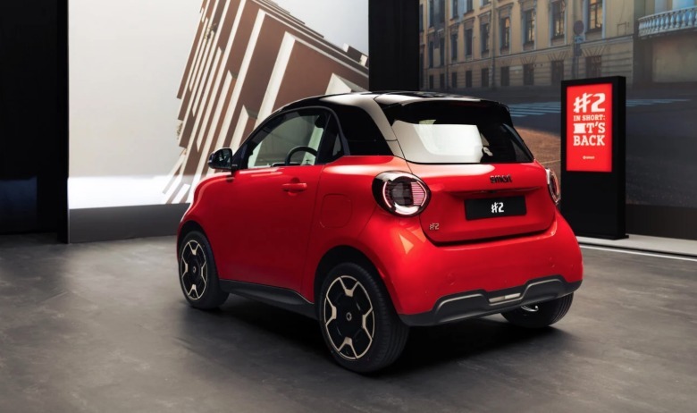 A red Smart #2 on a showroom.