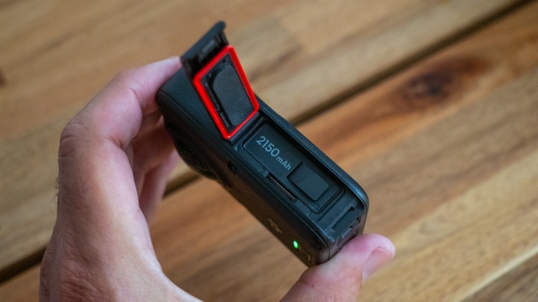 The battery compartment of DJI's Osmo 360 II showing the new 2150mAh battery and microSD card slot