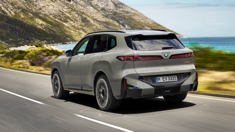 BMW's iX5 SUV shown from the rear quarter with a seascape in the background