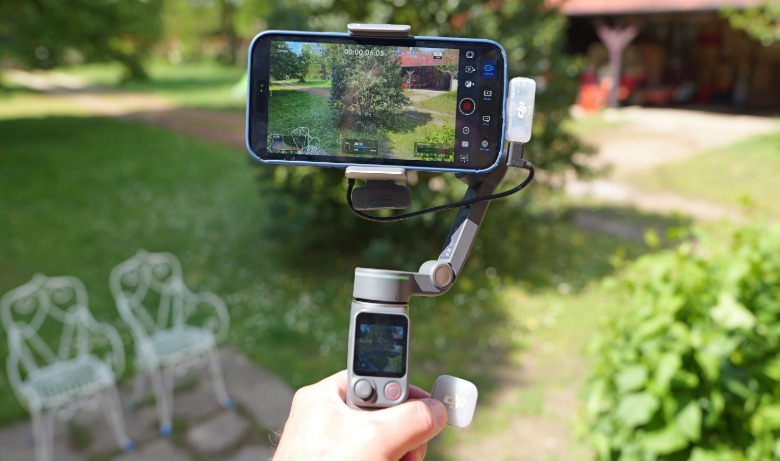 DJI's Osmo Pocket 8P gimbal shown with iPhone and DJI Mic Mini 2