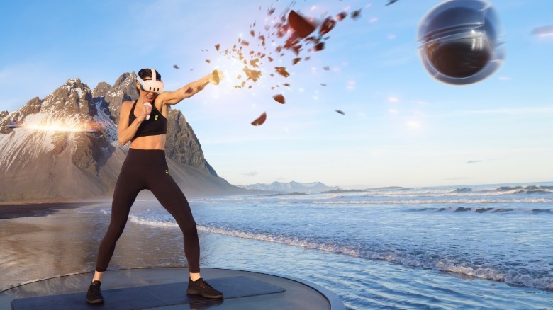 A person wearing a VR headset punching virtual objects.