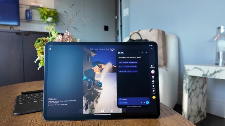 An Amazon Alexa Tablet 12 Pro on a table showing the Alexa app over a TikTok video.