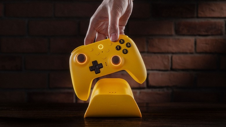 The Ultimate 2 controller and stand in yellow.