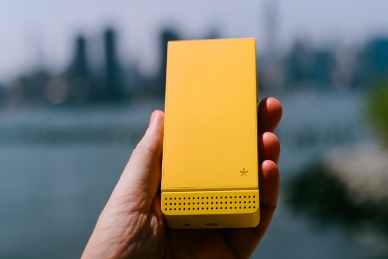 A yellowish Light Flip phone.