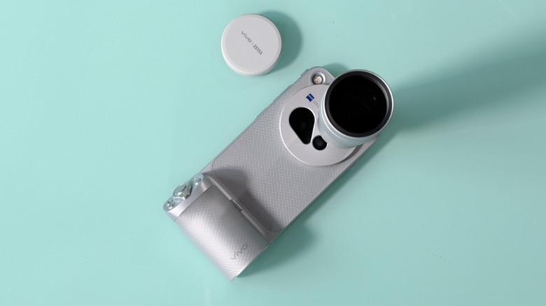 The Vivo X500 Pro Max inside its camera grip case with teleconverter attachment.