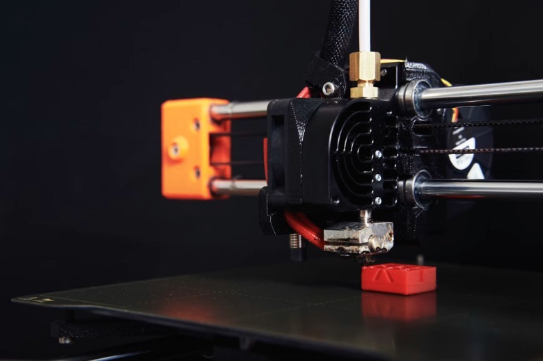 A 3D printer making a component.