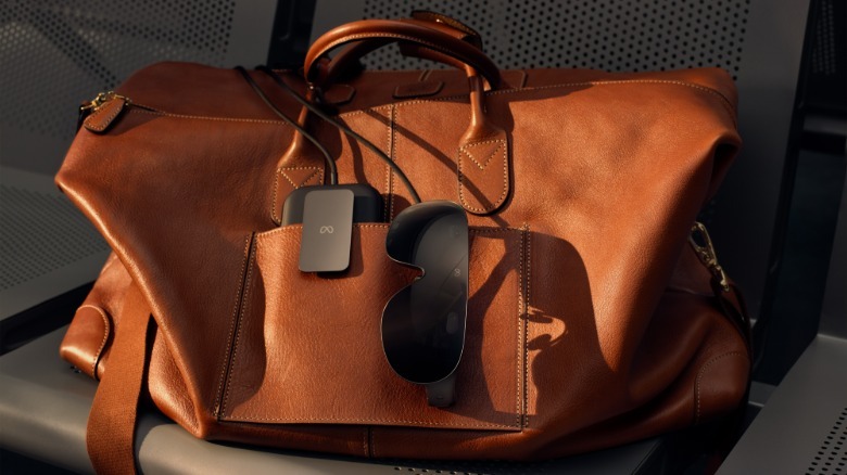 VR glasses and a tethered puck tucked into a bag.