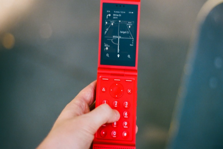 A reddish Light Flip phone.