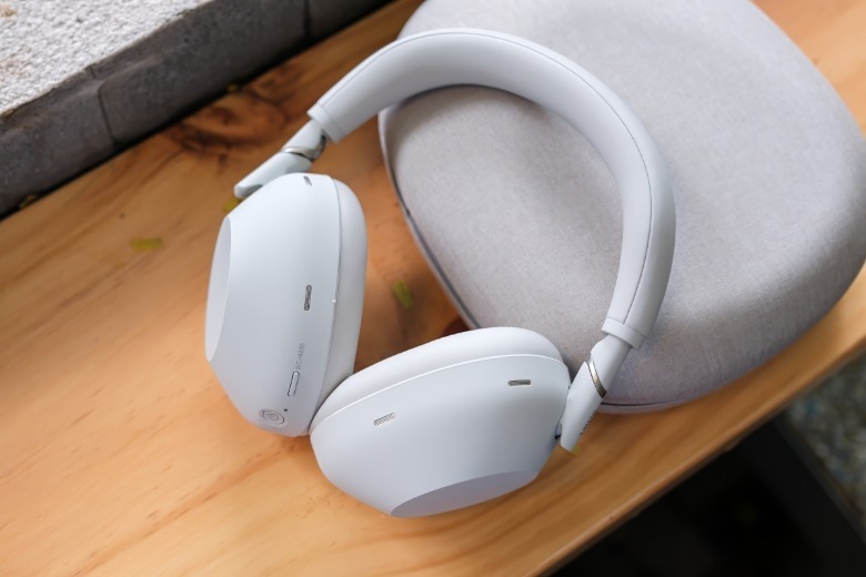 White Sony WH-1000XM6 headphones resting on top of their carrying case.